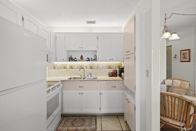 2800 Indian River Blvd Unit 7T, Vero Beach, FL 32960 - kitchen with white appliances, white cabinets, backsplash, light tile patterned flooring, and open shelves