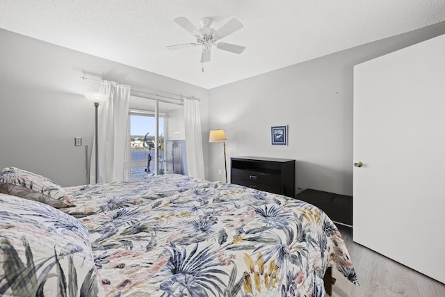 2800 Indian River Blvd Unit 7T, Vero Beach, FL 32960 - bedroom with access to outside, wood finished floors, ceiling fan, and a textured ceiling