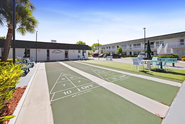 2800 Indian River Blvd Unit 7T, Vero Beach, FL 32960 - view of home's community with uncovered parking, shuffleboard, and a yard