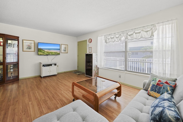 2800 Indian River Blvd Unit 7T, Vero Beach, FL 32960 - living room featuring wood finished floors, a textured ceiling, and beverage cooler