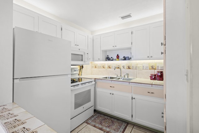 2800 Indian River Blvd Unit 7T, Vero Beach, FL 32960 - kitchen featuring white appliances, white cabinets, light countertops, and light tile patterned floors