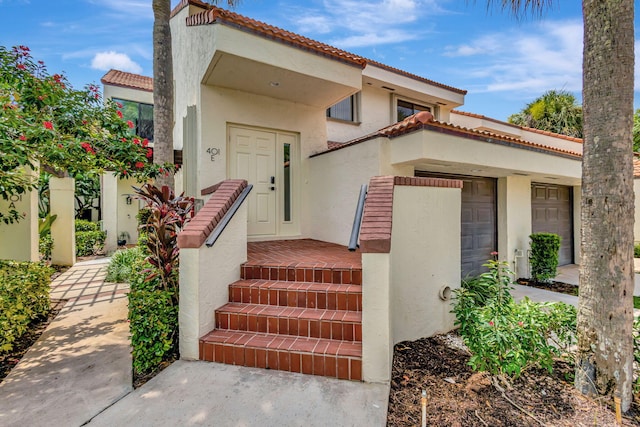 401 Sea Oats Dr E Unit E, Juno Beach, FL 33408 - doorway to property with a tiled roof and stucco siding