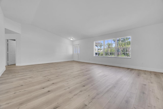 2432 SE Floresta Dr, Port Saint Lucie, FL 34984 - spare room with vaulted ceiling and light wood-style flooring