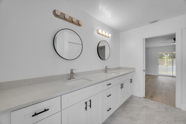 2432 SE Floresta Dr, Port Saint Lucie, FL 34984 - bathroom featuring double vanity, marble finish flooring, and a ceiling fan