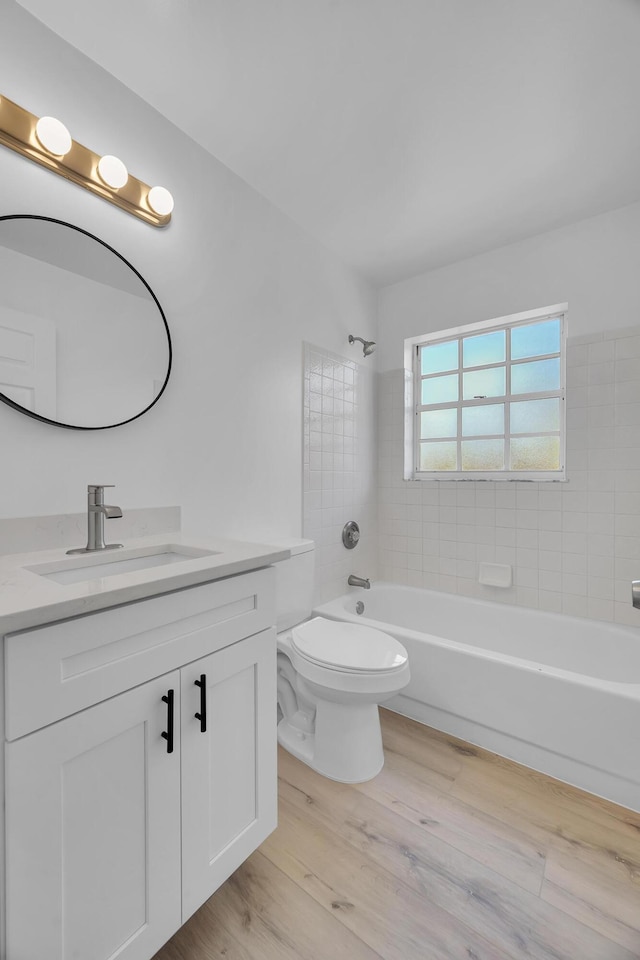 2432 SE Floresta Dr, Port Saint Lucie, FL 34984 - bathroom with vanity, wood finished floors, and tub / shower combination