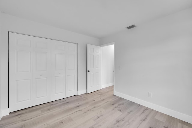2432 SE Floresta Dr, Port Saint Lucie, FL 34984 - unfurnished bedroom with light wood-style flooring and a closet