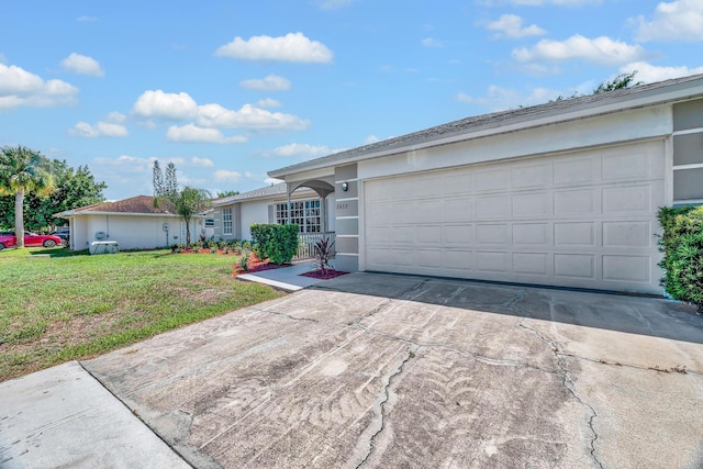 2432 SE Floresta Dr, Port Saint Lucie, FL 34984 - single story home with concrete driveway, stucco siding, a front yard, and a garage