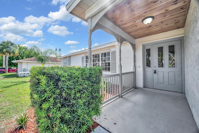 2432 SE Floresta Dr, Port Saint Lucie, FL 34984 - doorway to property with stucco siding and a yard