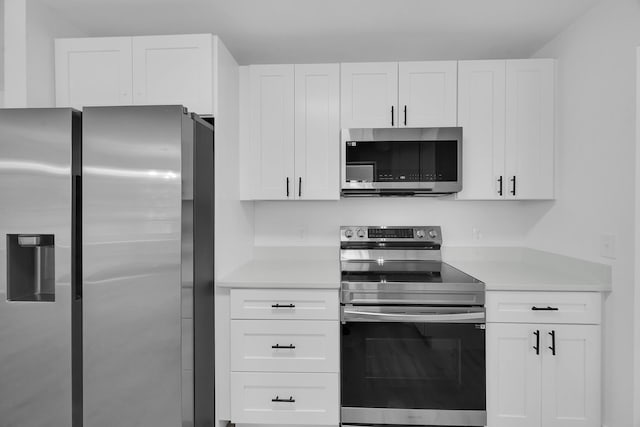 2432 SE Floresta Dr, Port Saint Lucie, FL 34984 - kitchen featuring appliances with stainless steel finishes, light countertops, and white cabinetry