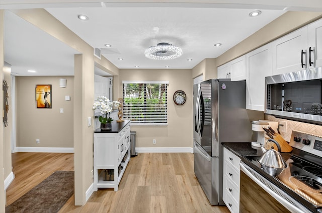 7270 Ashford Pl Unit 104, Delray Beach, FL 33446 - kitchen featuring stainless steel appliances, light wood-style flooring, white cabinetry, backsplash, and recessed lighting
