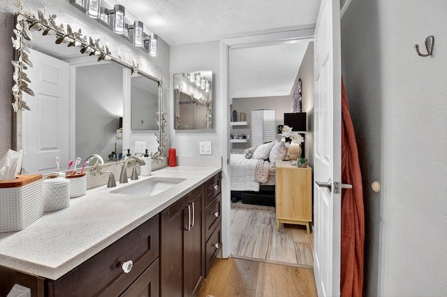 7270 Ashford Pl Unit 104, Delray Beach, FL 33446 - ensuite bathroom with vanity and wood finished floors