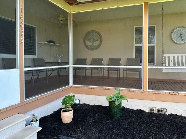 14895 24th Cir N, Loxahatchee Groves, FL 33470 - view of patio / terrace with a sunroom