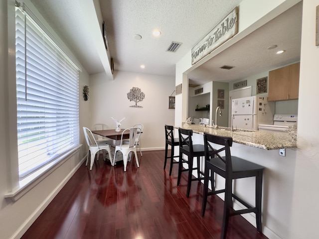 14895 24th Cir N, Loxahatchee Groves, FL 33470 - dining room featuring dark wood-style flooring, beam ceiling, recessed lighting, and a textured ceiling