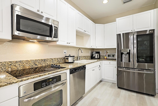 6964 Julia Gardens Dr, Coconut Creek, FL 33073 - kitchen featuring stainless steel appliances, light stone countertops, white cabinets, and recessed lighting