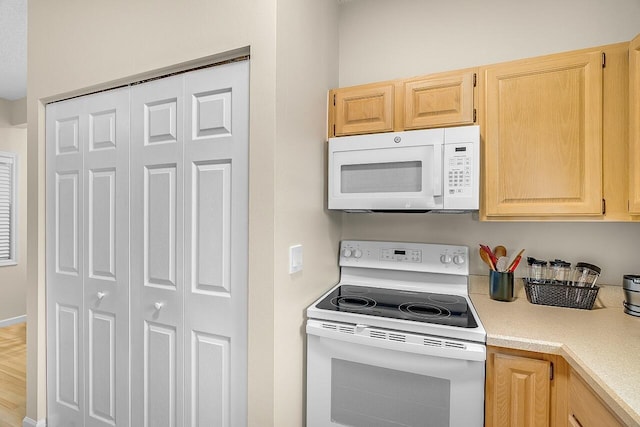 420 Hawthorne Ln, Vero Beach, FL 32962 - kitchen featuring white appliances, light brown cabinets, and light countertops