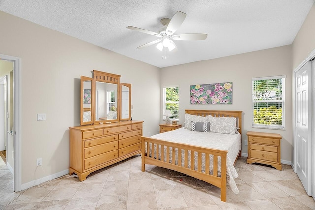420 Hawthorne Ln, Vero Beach, FL 32962 - bedroom with a closet, a textured ceiling, a ceiling fan, and light tile patterned floors