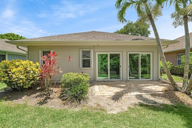 420 Hawthorne Ln, Vero Beach, FL 32962 - rear view of house with roof with shingles and a patio