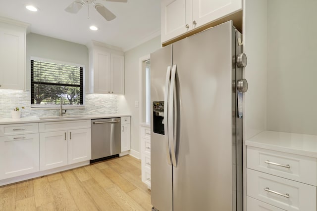 300 Intracoastal Pl Unit 204, Jupiter, FL 33469 - kitchen featuring stainless steel appliances, light wood-style flooring, ceiling fan, white cabinetry, and tasteful backsplash