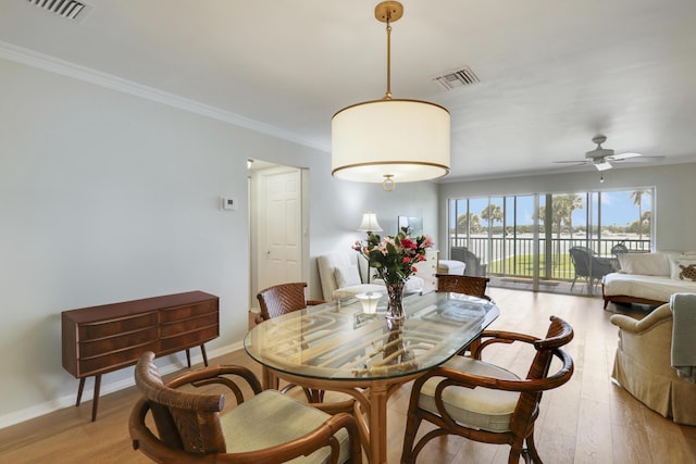 300 Intracoastal Pl Unit 204, Jupiter, FL 33469 - dining area with ornamental molding, light wood finished floors, a ceiling fan, and a water view