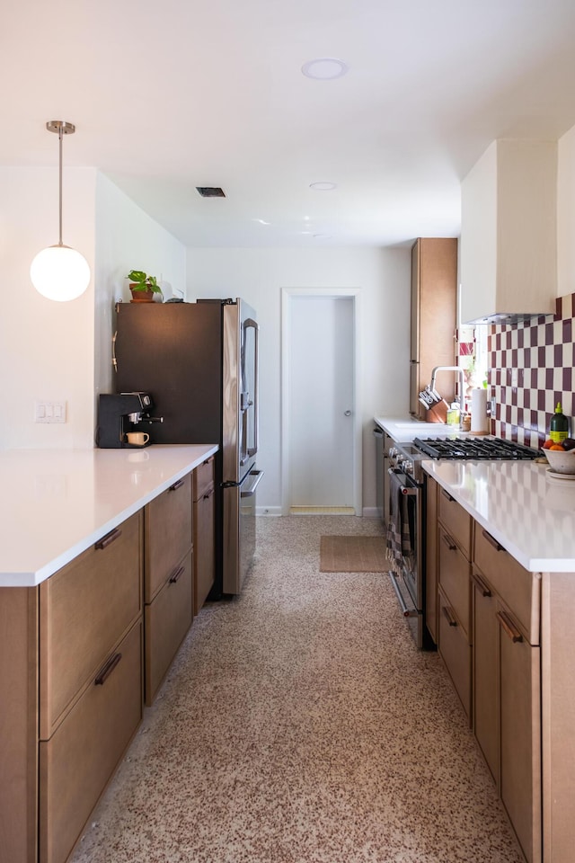 2931 SE Morningside Blvd, Port Saint Lucie, FL 34952 - kitchen with stainless steel appliances, tasteful backsplash, light countertops, brown cabinetry, and pendant lighting