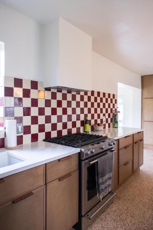 2931 SE Morningside Blvd, Port Saint Lucie, FL 34952 - kitchen with stainless steel range with gas cooktop, light countertops, and tasteful backsplash