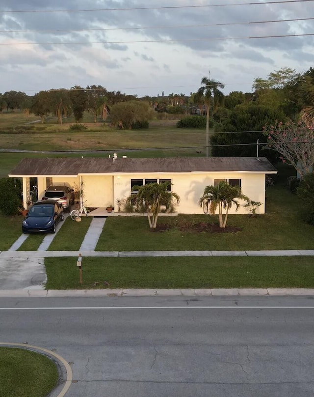 2931 SE Morningside Blvd, Port Saint Lucie, FL 34952 - view of front facade with stucco siding, a front yard, and driveway