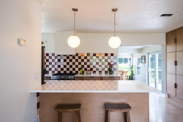 2931 SE Morningside Blvd, Port Saint Lucie, FL 34952 - kitchen with tasteful backsplash, a breakfast bar area, stove, and light countertops