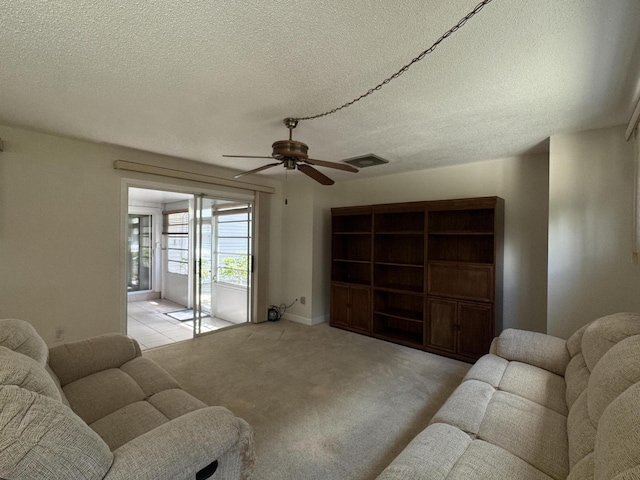 3216 59th Ave, Vero Beach, FL 32966 - carpeted living area featuring ceiling fan and a textured ceiling