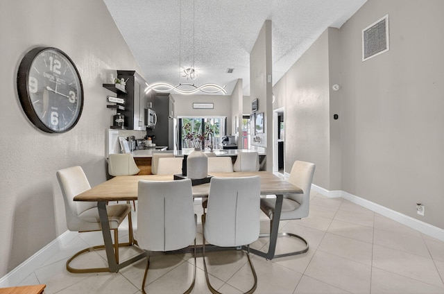 1005 NW 53rd St, Deerfield Beach, FL 33064 - dining room featuring a textured ceiling, light tile patterned flooring, and a chandelier