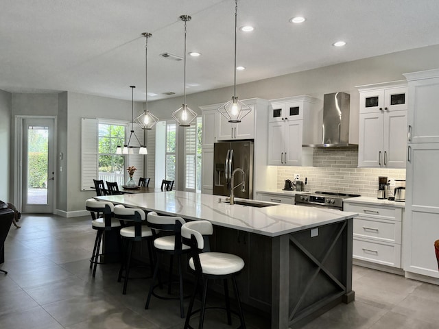 404 NE Ginger Lily Place, Saint Lucie, FL 34983 - kitchen with wall chimney range hood, stainless steel range with electric stovetop, tasteful backsplash, fridge with ice dispenser, and recessed lighting