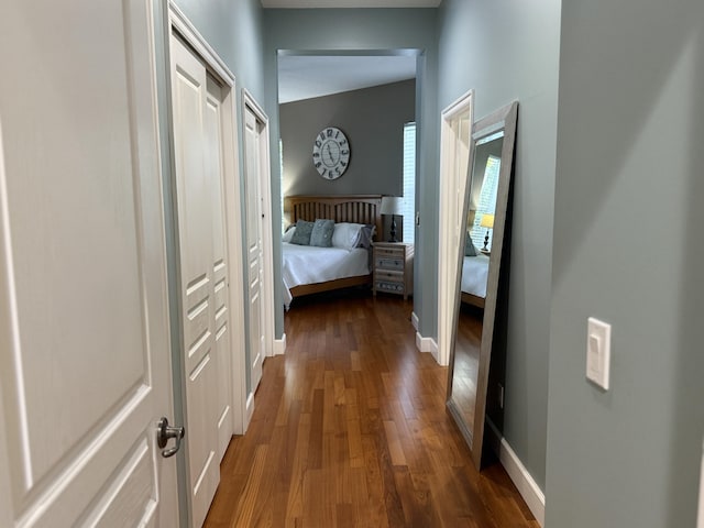 404 NE Ginger Lily Place, Saint Lucie, FL 34983 - hallway featuring dark wood-style flooring and baseboards