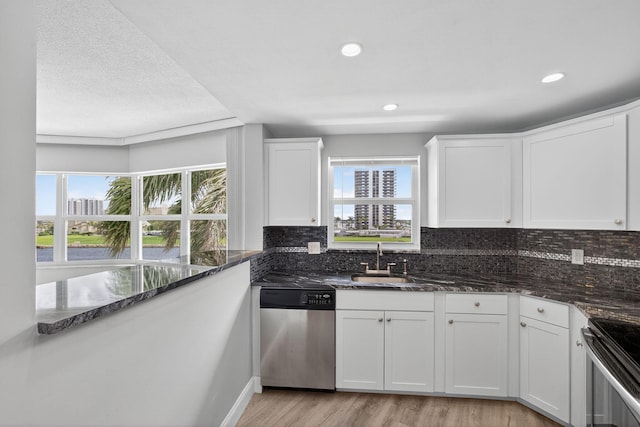 28 Yacht Club Dr Unit 409, North Palm Beach, FL 33408 - kitchen with stainless steel appliances, white cabinets, backsplash, and recessed lighting