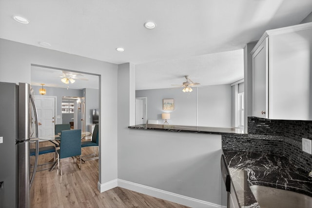28 Yacht Club Dr Unit 409, North Palm Beach, FL 33408 - kitchen featuring freestanding refrigerator, a ceiling fan, light wood-style floors, backsplash, and recessed lighting