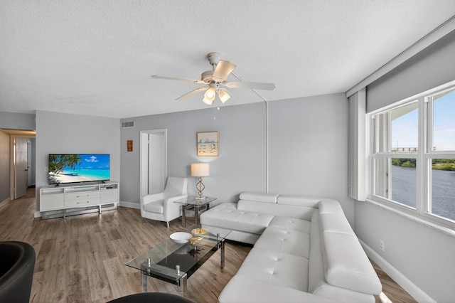 28 Yacht Club Dr Unit 409, North Palm Beach, FL 33408 - living area featuring a ceiling fan, wood finished floors, and a textured ceiling