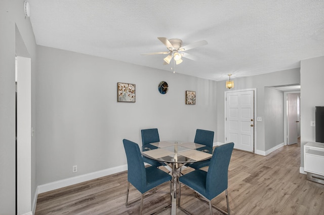 28 Yacht Club Dr Unit 409, North Palm Beach, FL 33408 - dining space featuring light wood finished floors, ceiling fan, and a textured ceiling