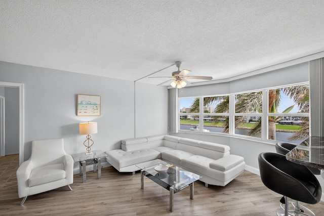 28 Yacht Club Dr Unit 409, North Palm Beach, FL 33408 - living area featuring ceiling fan, a textured ceiling, and wood finished floors