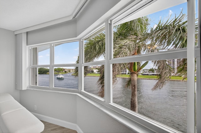 28 Yacht Club Dr Unit 409, North Palm Beach, FL 33408 - unfurnished sunroom with a water view and wood finished floors