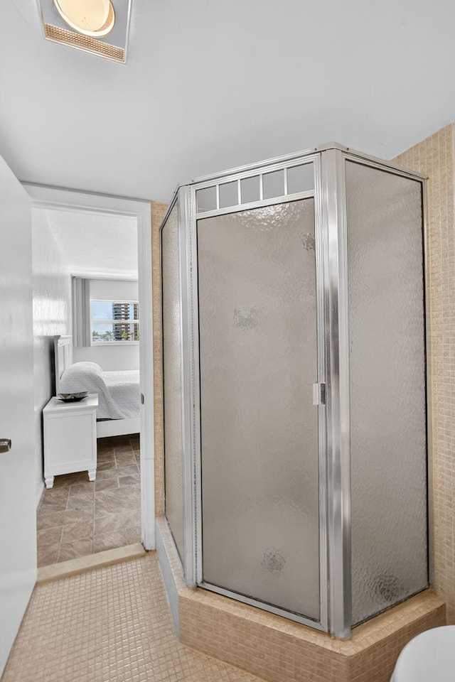 28 Yacht Club Dr Unit 409, North Palm Beach, FL 33408 - bathroom with a stall shower, connected bathroom, and tile patterned flooring