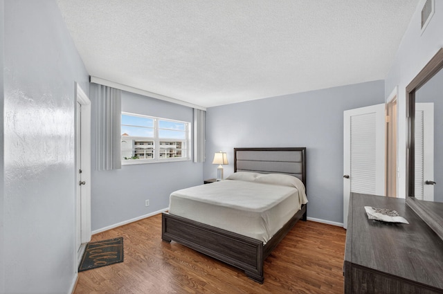 28 Yacht Club Dr Unit 409, North Palm Beach, FL 33408 - bedroom with wood finished floors and a textured ceiling
