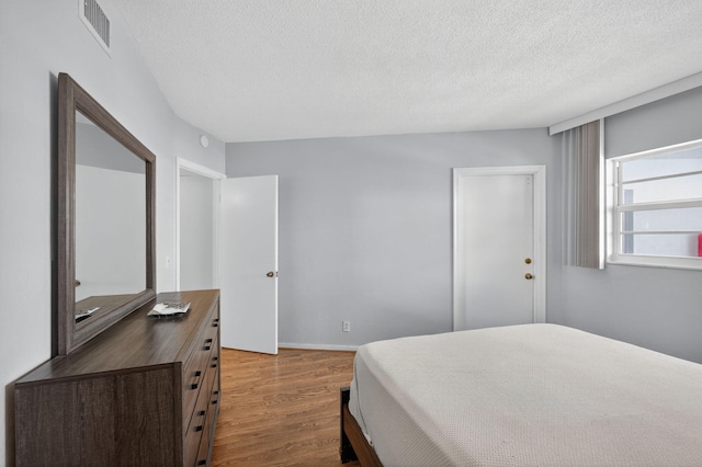 28 Yacht Club Dr Unit 409, North Palm Beach, FL 33408 - bedroom featuring wood finished floors and a textured ceiling