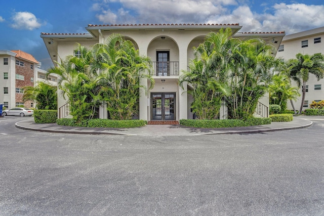 28 Yacht Club Dr Unit 409, North Palm Beach, FL 33408 - view of front of property featuring french doors, a balcony, and stucco siding