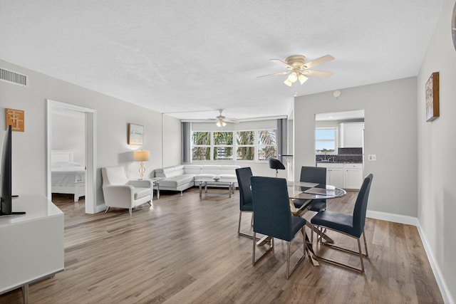 28 Yacht Club Dr Unit 409, North Palm Beach, FL 33408 - dining room with ceiling fan, wood finished floors, and a textured ceiling