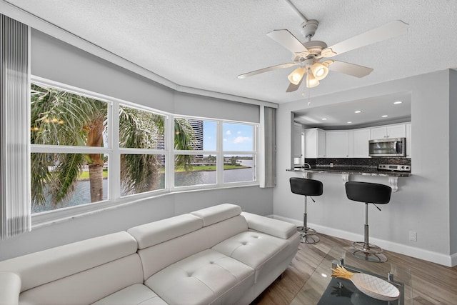 28 Yacht Club Dr Unit 409, North Palm Beach, FL 33408 - living room with wood finished floors, ceiling fan, a textured ceiling, and recessed lighting