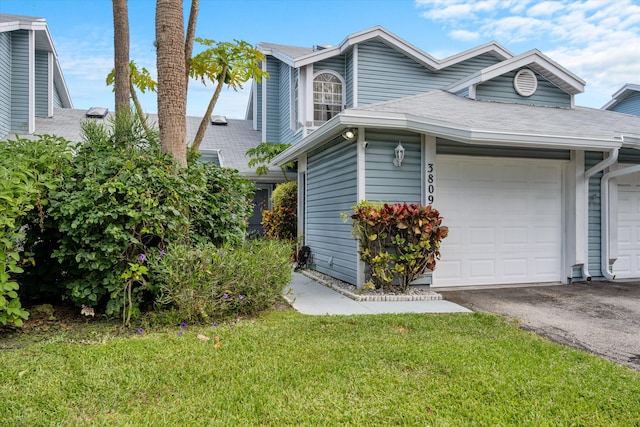 3809 Island Club Cir E, Lake Worth, FL 33462 - view of side of home featuring driveway, a yard, a shingled roof, and an attached garage