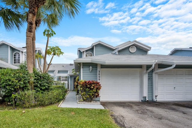 3809 Island Club Cir E, Lake Worth, FL 33462 - view of front facade with driveway, an attached garage, and a shingled roof