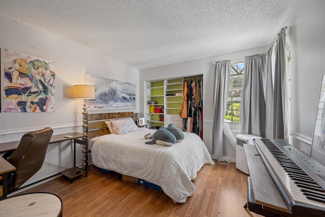 3809 Island Club Cir E, Lake Worth, FL 33462 - bedroom with a textured ceiling, a closet, and light wood finished floors