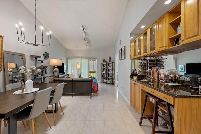 3809 Island Club Cir E, Lake Worth, FL 33462 - dining room featuring a chandelier, light tile patterned floors, rail lighting, and lofted ceiling
