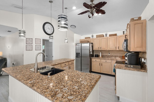 5647 SE Sailfish Way, Stuart, FL 34997 - kitchen with stainless steel fridge with ice dispenser, light brown cabinets, a ceiling fan, a spacious island, and light wood finished floors