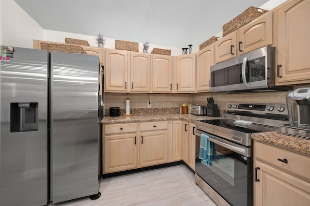 5647 SE Sailfish Way, Stuart, FL 34997 - kitchen featuring stainless steel appliances, light brown cabinetry, and light stone countertops