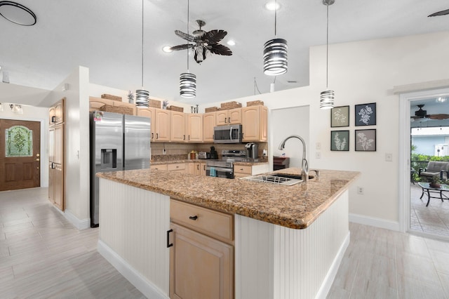 5647 SE Sailfish Way, Stuart, FL 34997 - kitchen featuring stainless steel appliances, light brown cabinets, ceiling fan, a large island with sink, and light stone counters